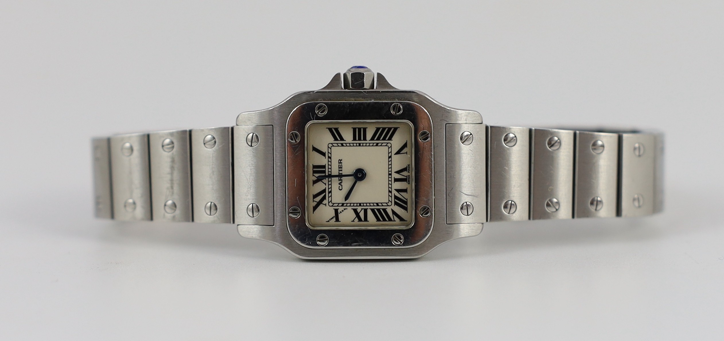 A lady's stainless steel Cartier Santos quartz wrist watch, on a stainless steel Cartier bracelet